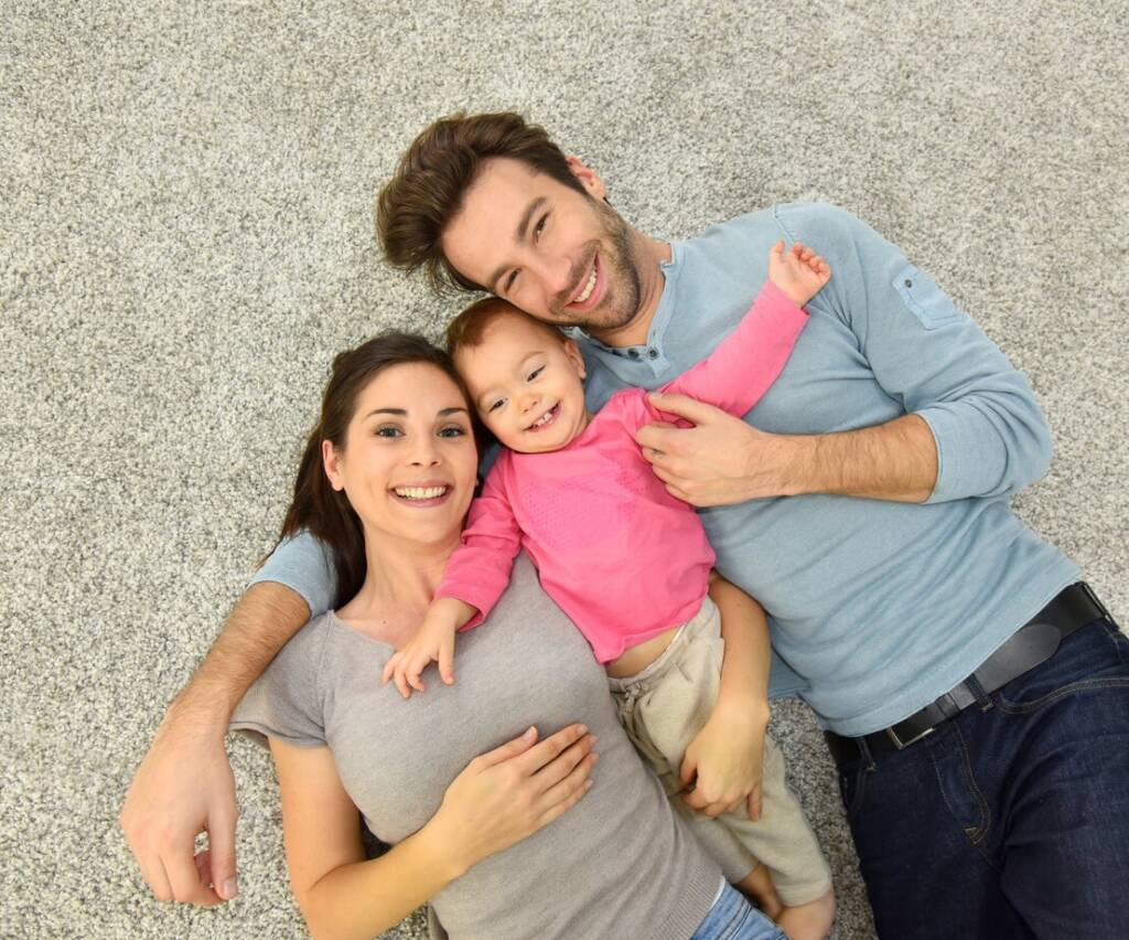 Family laying in a carpeted floor